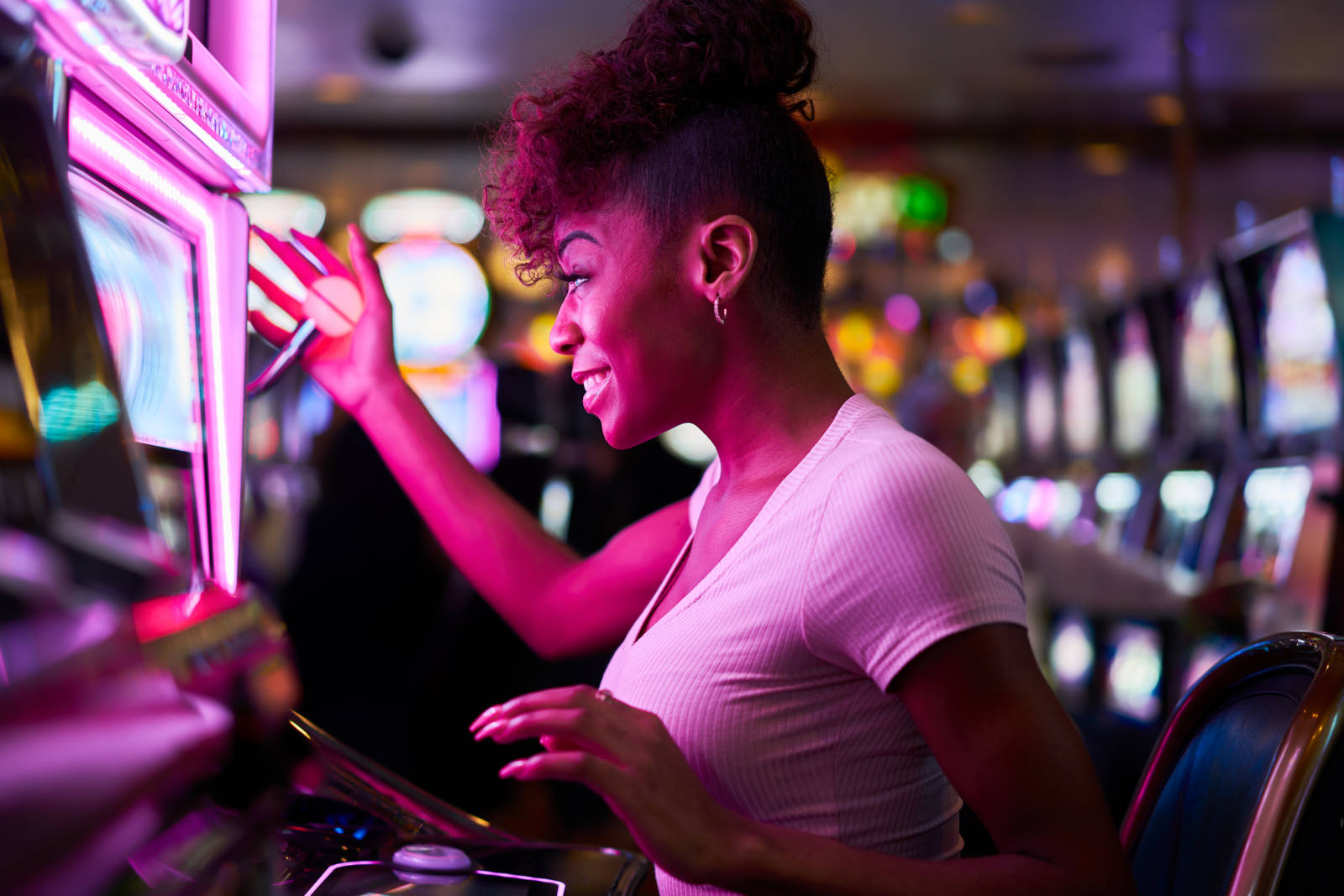 Women playing a slot machine at a Casino.