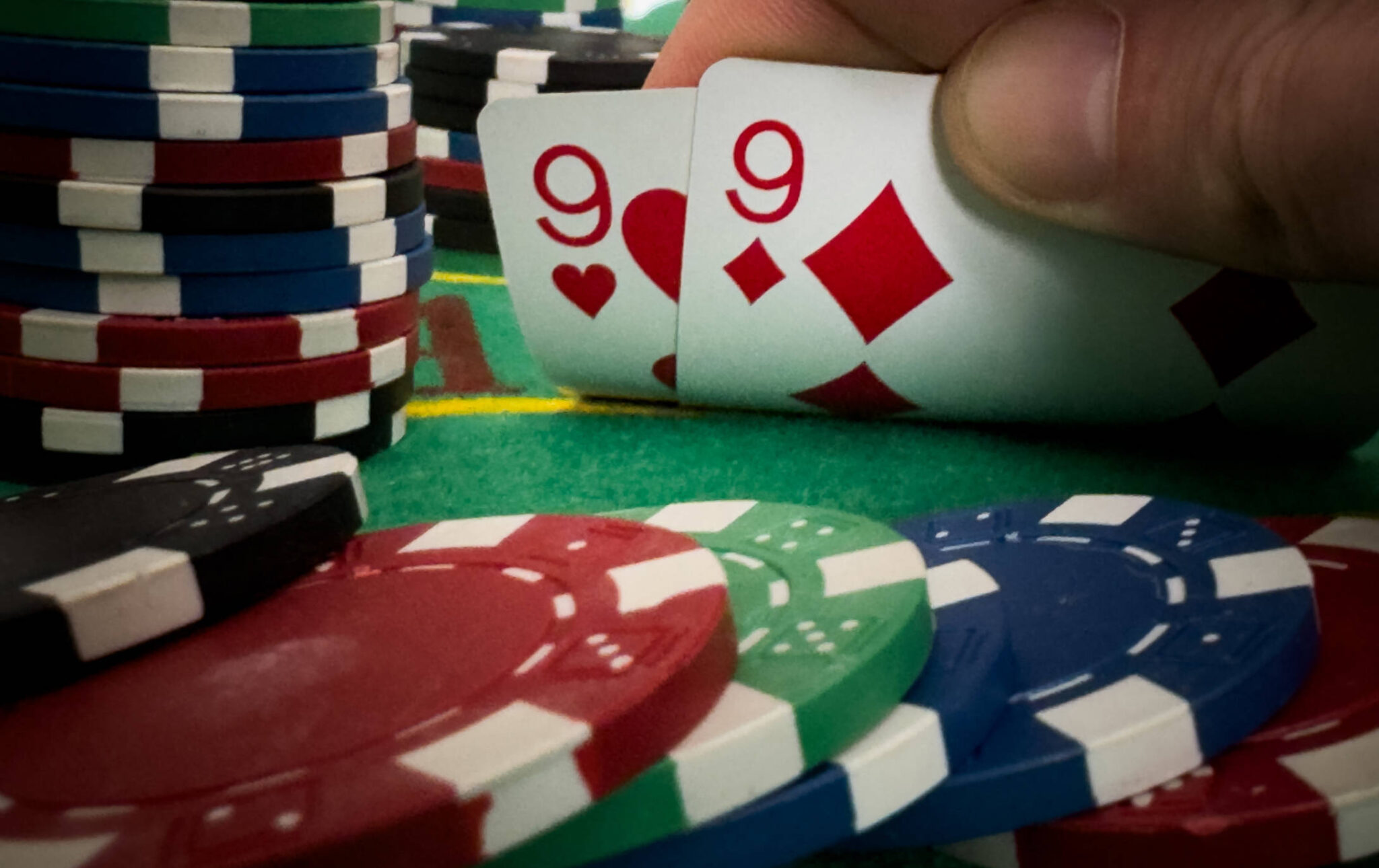 Player peeking cards in Blackjack game.