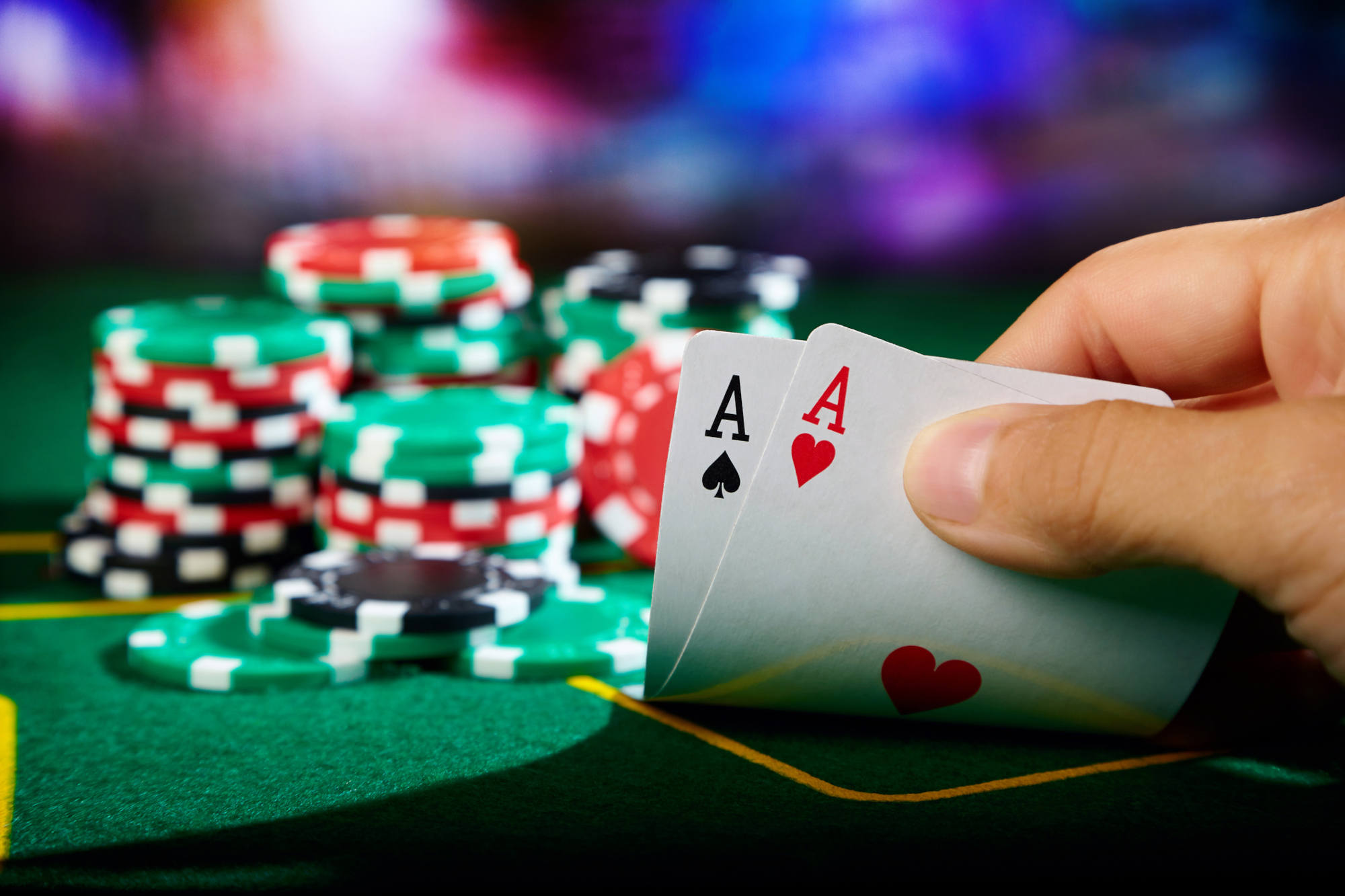 Player showing cards at poker table. Winning hand.