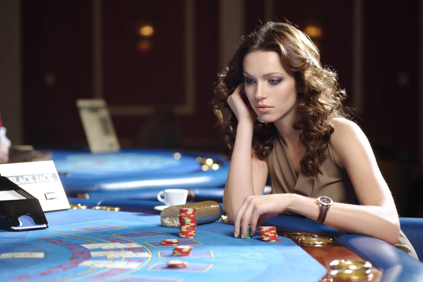 young beautiful woman playing blackjack in casino
