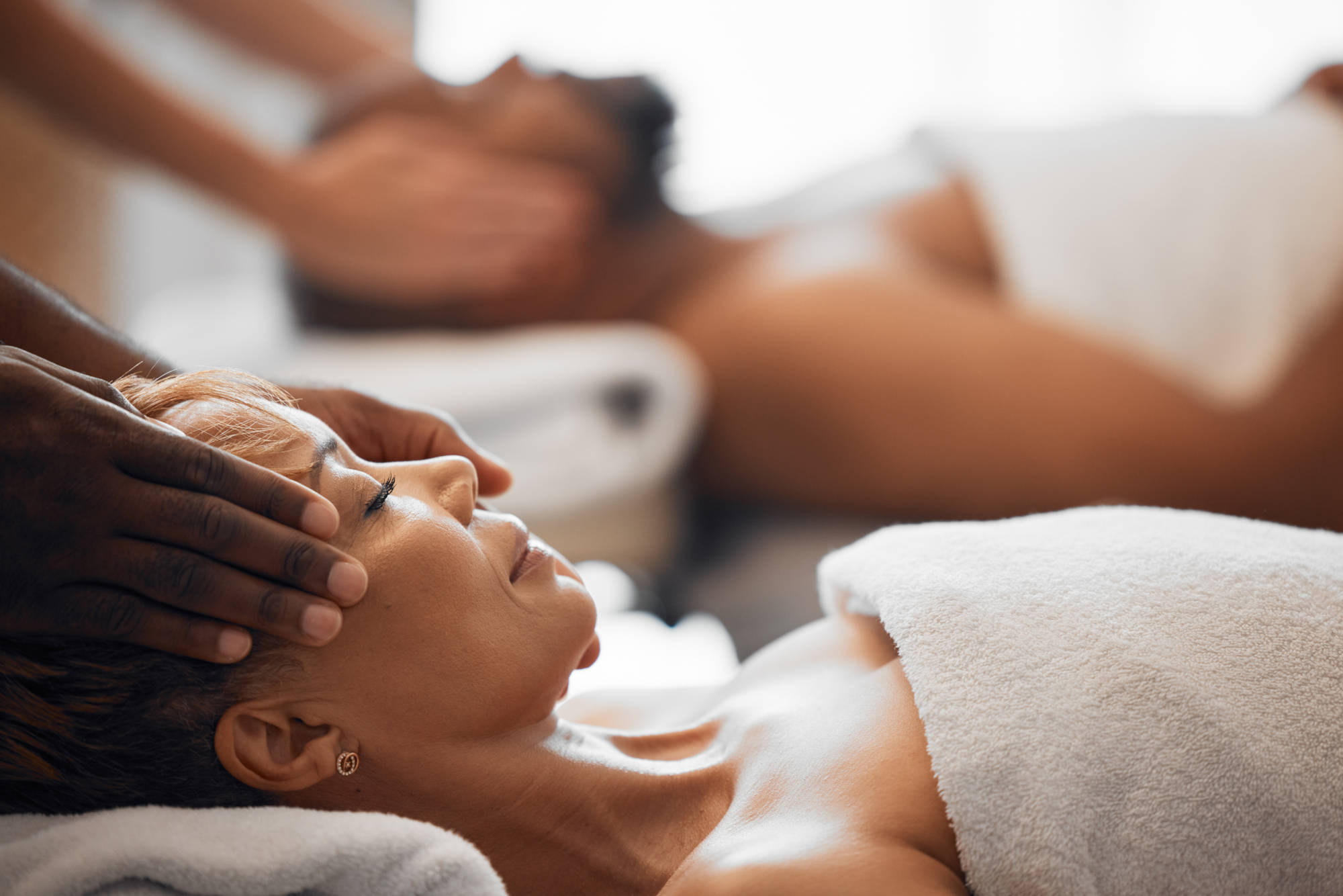 Couple enjoying a Spa day on message tables.