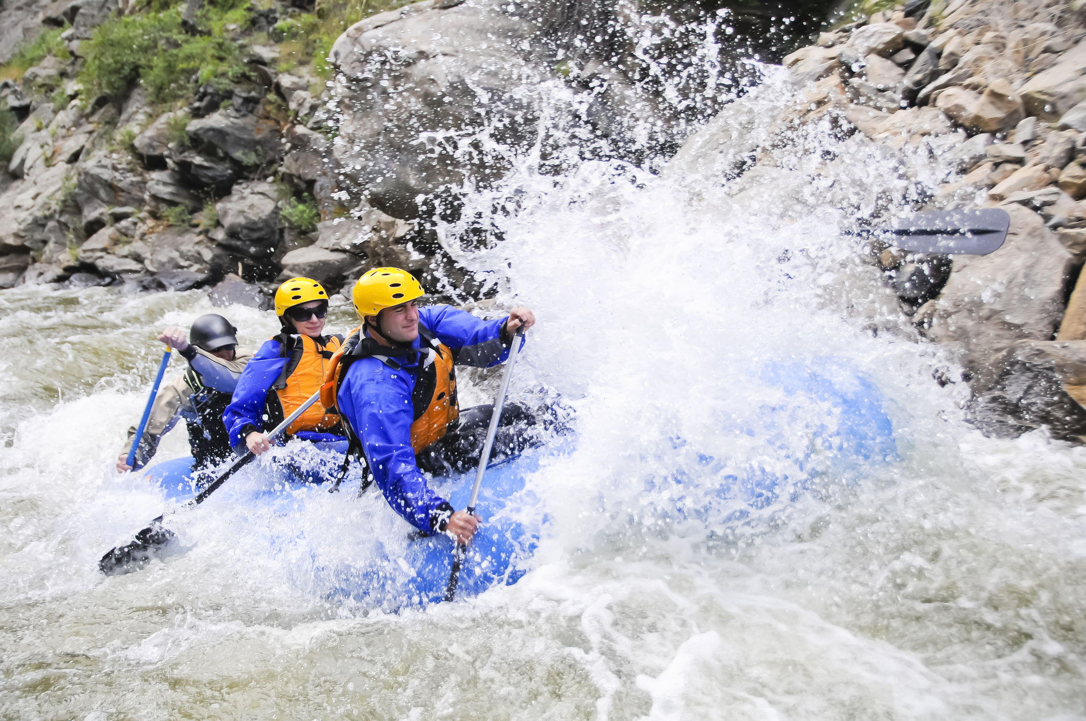 A group of friends whitewater raft on in Colorado