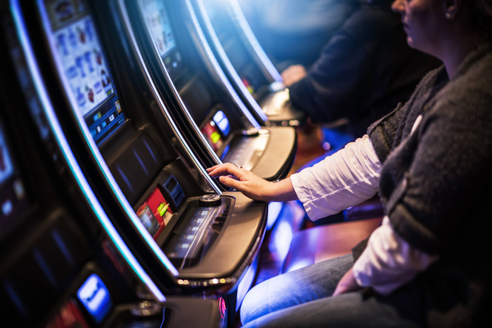 People Playing Video Slot Machines Inside a Casino.